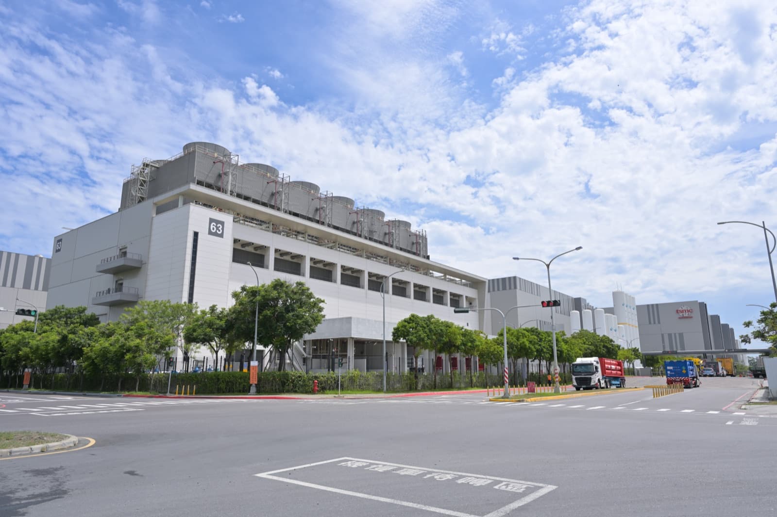 TSMC's Fab 18 in the Tainan science park, where five- and three-nanometre nodes are made. The phrase 'sacred mountain that guards the country' moved from industry talk into politics, writing one company into national security.