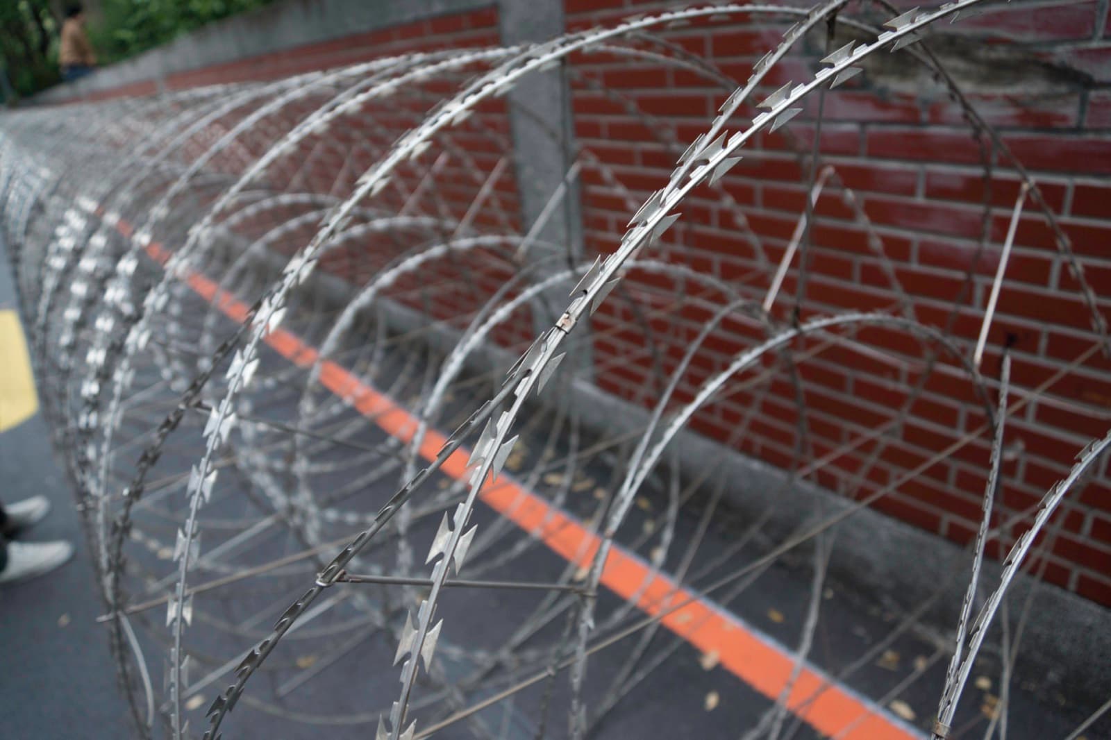 Razor wire on the wall outside the Legislative Yuan. On the night of 23 March the crowd got into the Executive Yuan and was cleared before dawn with water cannon and batons — those days seen from the state's side.