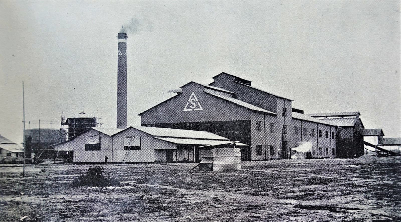 The Lin Pen-yuan sugar company's mill. The Government-General drew raw-material zones: cane growers inside a zone could sell only to the one designated company, at the price that company set.