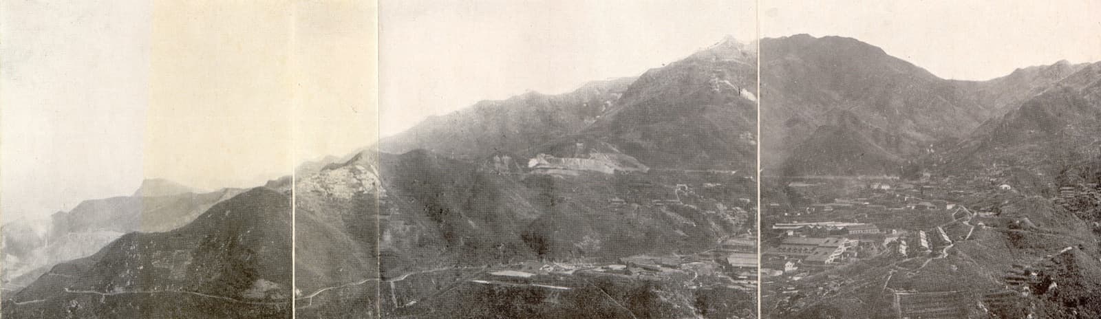 A panorama of the Jinguashi mine run by the Tanaka Group, published in the Government-General of Taiwan's statistical handbook of 1912. The clusters of buildings in the valley are the mine works and the settlement. Thirty years later the prisoner of war camp was set up in these hills.
